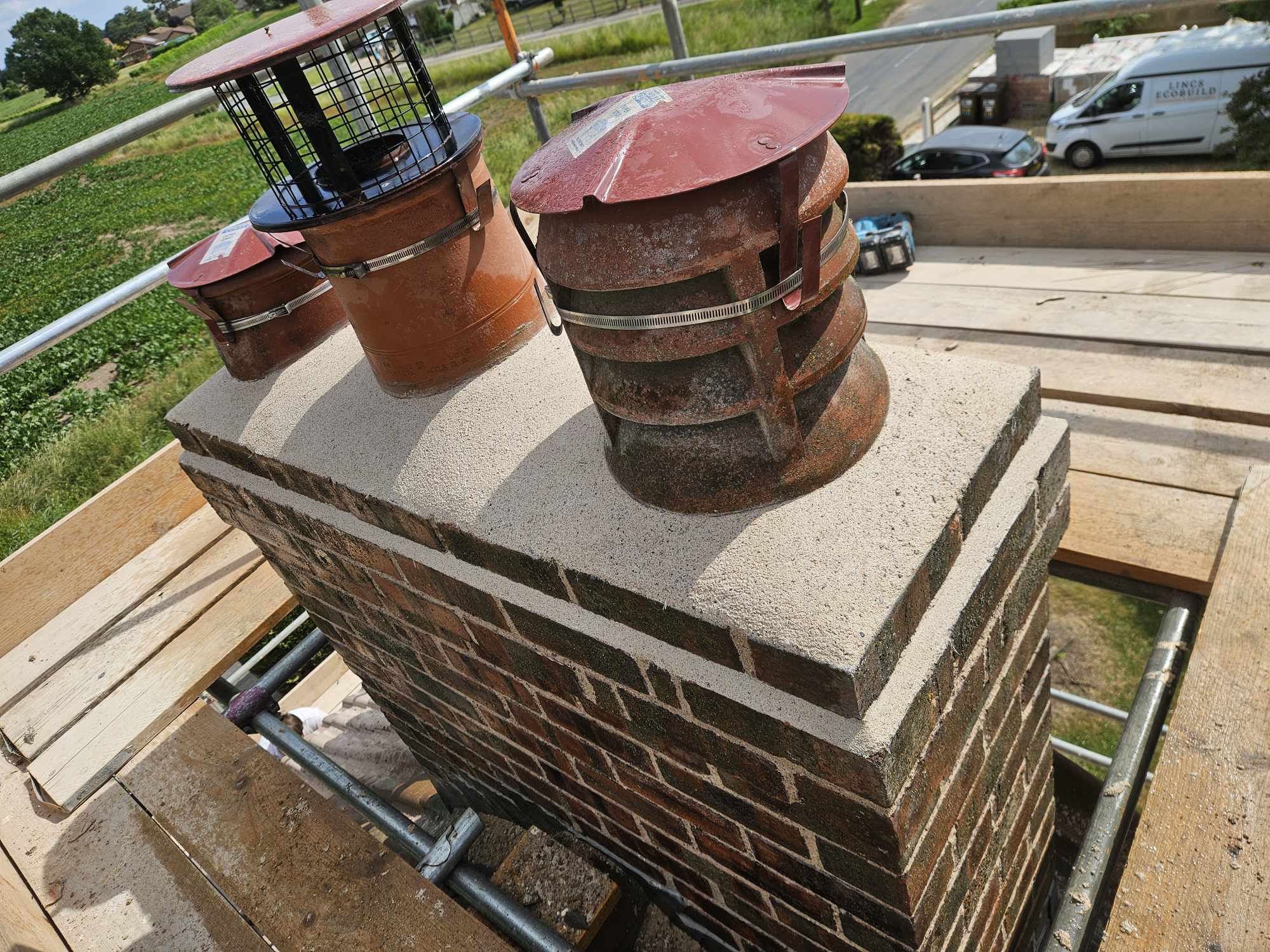 Restored brick chimney with new pots